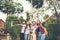 Group of happy friends raised hands on background of city. Success ,  Enjoy holiday