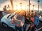 Group of happy friends standing in front of convertible car and taking selfie with mobile phone