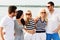 Group of happy friends in striped clothes on beach