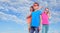 Group of happy friends wearing eyeglasses against blue sky