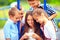 Group of happy kids playing online games together, outdoors