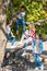 group of happy multiethnic teenagers sitting on tree