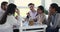 Group of happy multiracial best friends, talking, laughing at meeting