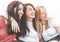 Group of happy multiracial female tourists having fun and smiling - Best friends enjoy their vacation while relaxing with the sea