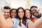 Group of happy multiracial teenagers having fun smiling taking a selfie portrait together on a students meeting. Five