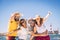 Group of happy people and cheerful adults friends have fun together during summer holiday vacation at the beach - enjoying the