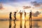 Group of happy people dancing at beach full moon party