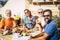 Group of happy people having breakfast at home in the terrace together with love - faughter, son, grandma and grandpa eating and