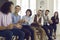 Group of happy people thanking coach or coworker for interesting talk in business meeting