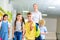 group of happy schoolchildren and teacher walking