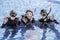 A group of happy scuba divers smiling at the camera