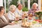 Group of happy seniors eating a dinner