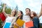 Group of happy students showing triumph gesture