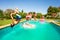 Group of happy teens having fun in swimming pool