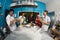 Group of happy young asian pastry bakery chef preparing dough with flour working inside kitchen