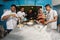 Group of happy young asian pastry chef preparing dough with flour, profesional chef working at kitchen