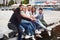 Group of happy young friends on the pier, pleasure in playing creates emotional life