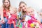 Group of happy young mothers watching their cute and healthy babies play