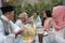 Group of happy young muslim having dinner outdoor during ramadan