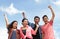 Group of happy young people with hands up