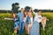 Group of happy young people posing in rapeseed