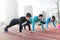 Group of healthy sporty determined friends fitness training toge