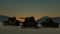 Group of Heavy Military Tanks Moving in Desert Landscape at Sunset. 3D Rendering