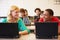 Group Of High School Students In Class Using Laptops