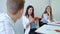 Group of high school students sitting in classroom and having conversation practice