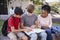 Group Of High School Students Studying Outdoors During Recess