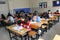 Group of high school students taking a test in classroom.