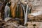 Group of high waterfalls flowing down in Georgia. Martvili canyon. Okatse canyon