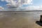 Group of hikers in the bay at low tide. Hike in the bay with a knowledgeable guide. Mont Saint-Michel