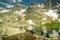 Group of hikers crossing mountain lake in High Tatras, Slovakia