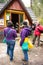 Group of hikers next to a wooden hut in a forest of the Karkonosze Mountains, Poland