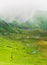 Group of hikers passing through a foggy valley in the mountains