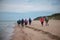 Group of hikers on the sandy coastline of Baltic sea