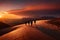 A group of hikers silhouetted against a vibrant orange and pink sunset over a rugged desert landscape