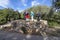 Group of hikers stand on top of a lime kiln on a sunny day