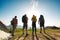 Group of hikers stands near tent