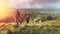 Group Of Hikers Walking Along The Green Hills, Rear View. Travel