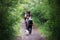 Group of hikers walks the path inside the woods