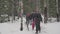 group of hikers walks in winter snowy forest, tourism, travel.