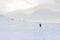 Group of hikers in winter mountains take path up to the peak