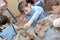 Group of hildren shaping clay in pottery studio