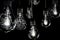 Group of incandescent light bulbs on black background with copy space. Generative AI