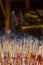 Group incense with candle and statue background