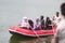 a group of Indonesian people is on inflatable boat without wearing a life jacket at Batukarut Lake or Situ Batukarut Sukabumi,