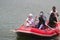 a group of Indonesian people is on inflatable boat without wearing a life jacket at Batukarut Lake or Situ Batukarut Sukabumi,