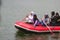 a group of Indonesian people is on inflatable boat without wearing a life jacket at Batukarut Lake or Situ Batukarut Sukabumi,